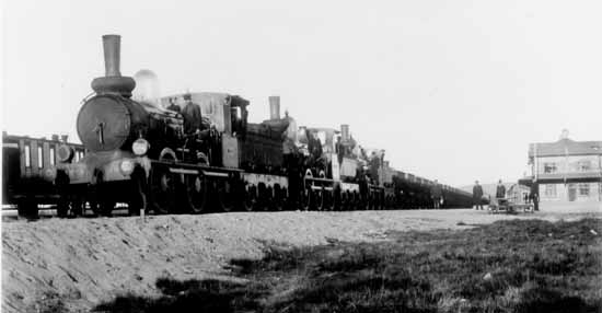 Iron ore train pulled by 3 engines waiting for depart from Gällivare station year 1895